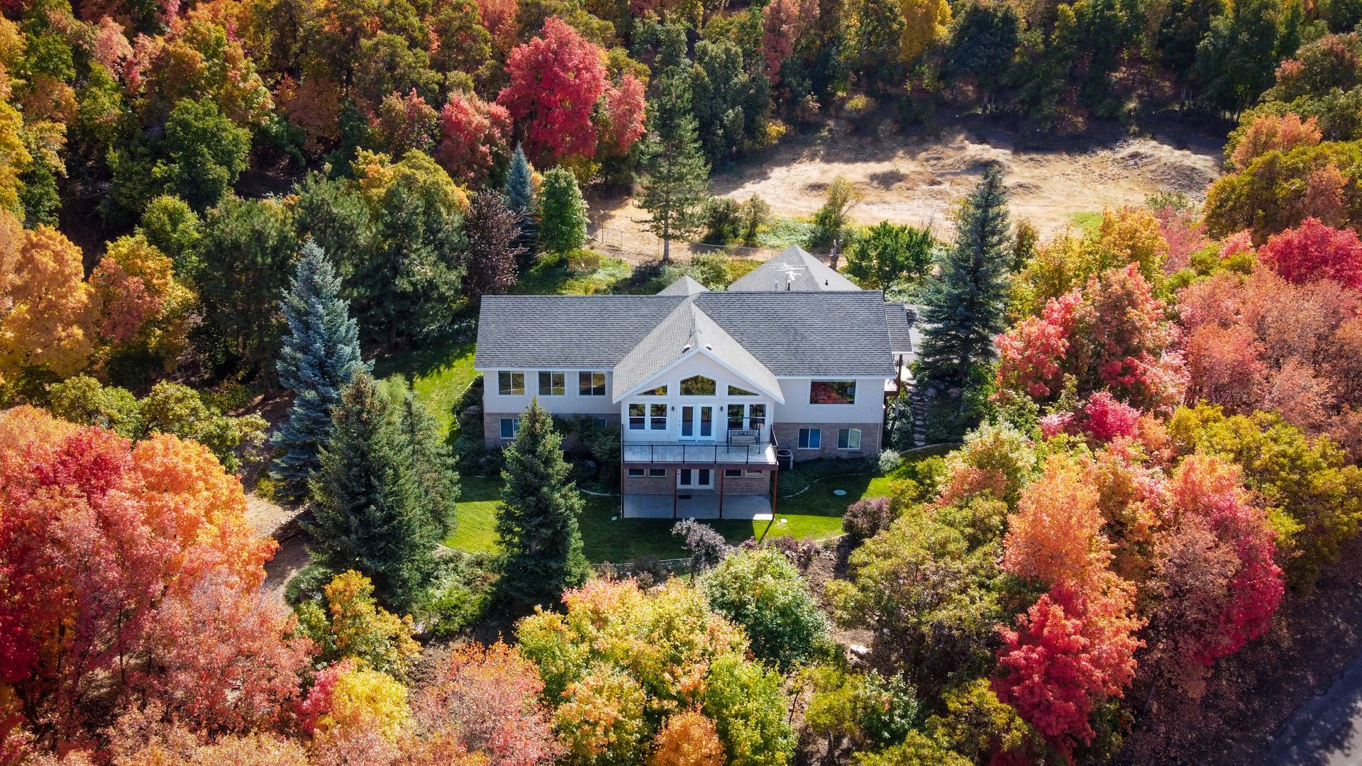 Santaquin home for sale surrounded by fall foliage near the orchards
